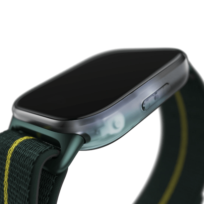 Close-up view of the Moto Watch Fit showcasing its sleek design, featuring a dark display and a green fabric strap with yellow accents.
