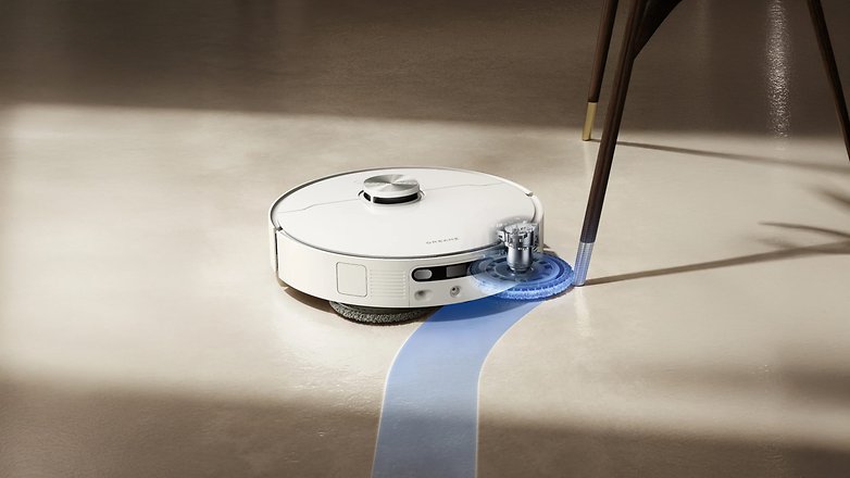 A Dreame L40 Ultra AE robotic vacuum cleaner mopping a floor under a table.