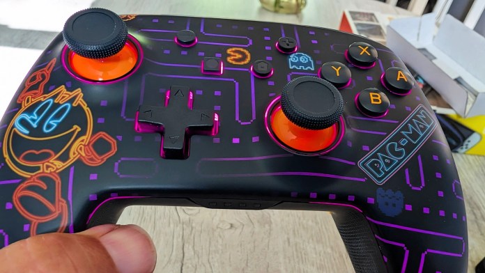 Close-up view of a PowerA Pac-Man Neon Arcade Controller for Nintendo Switch, featuring colorful designs inspired by the classic Pac-Man game, including character graphics and LED accents.
