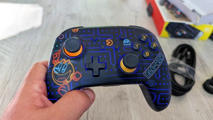 Close-up of a PowerA PAC-MAN Neon Arcade Controller for Nintendo Switch, featuring colorful LED lighting and retro design elements inspired by the classic PAC-MAN game.