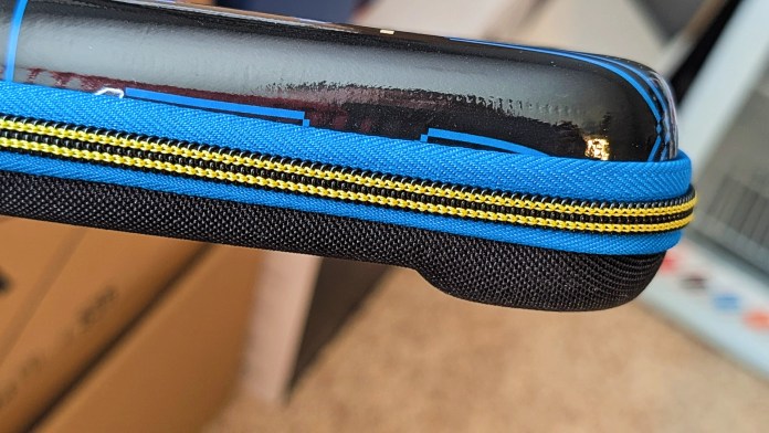 Close-up of the zipper and edge of a PowerA Pac-Man Protection Case for Nintendo Switch, featuring a blue and black design with a yellow zipper.
