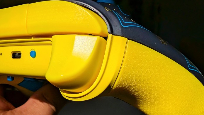 Close-up view of the PowerA Pac-Man Neon Arcade Controller for Nintendo Switch, showcasing its vibrant yellow design and textured grip.