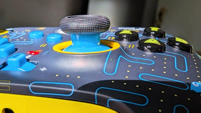 Close-up of a joystick on the PowerA Pac-Man Neon Arcade Controller, showcasing the retro design with colorful buttons and a textured grip.