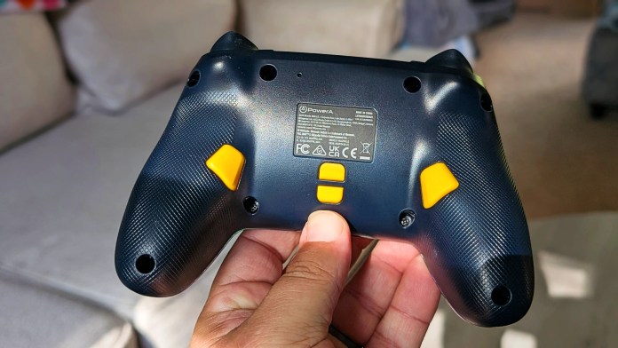 Close-up of the back of a PowerA Pac-Man wireless controller showing the textured grip, buttons, and branding.