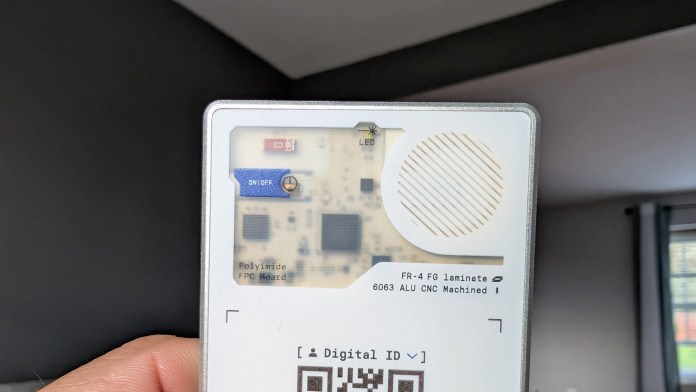 Close-up view of the back of the Rolling Square AirCard Pro Bluetooth tracker, displaying its components, including a power switch, LED indicator, and QR code for digital identification.