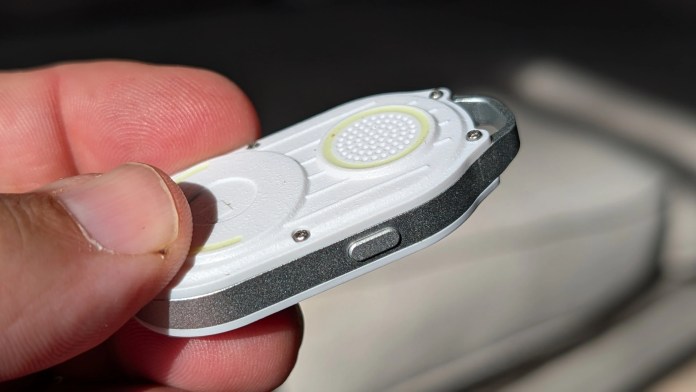Close-up image of the Rolling Square AirCard Pro Bluetooth tracker held in a person's hand, showcasing its sleek design and functionality.