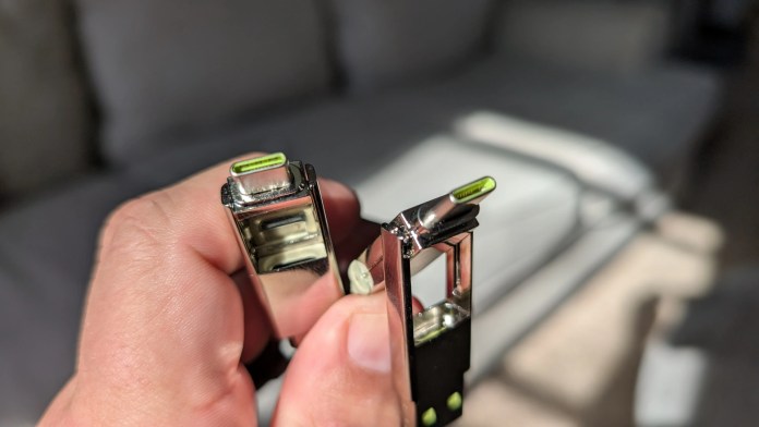 A close-up of a hand holding the Rolling Square inCharge XS Keyring Cable, showcasing its sleek design and charging connectors.