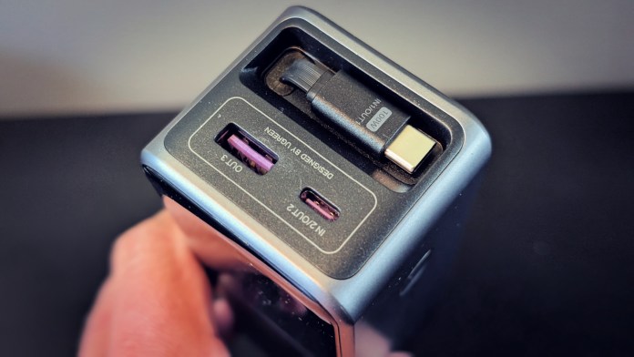 Close-up view of the UGREEN Nexode Retractable USB-C Cable 100W, showing two USB-C ports and a retractable cable feature on its casing.