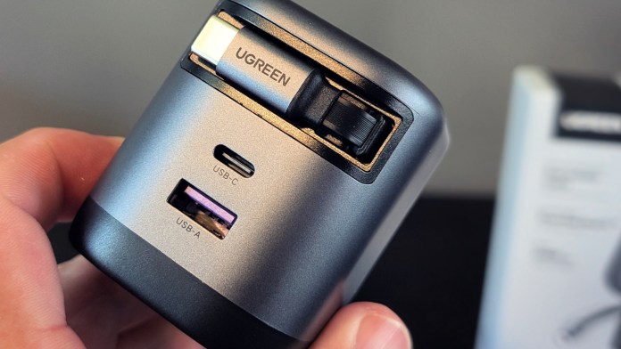 Close-up view of the UGREEN Nexode retractable car charger showing USB-C and USB-A ports, designed for efficient charging.