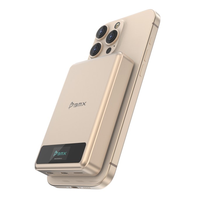 A gold SolidSafe power bank designed by BMX, positioned against a smartphone, showcasing its sleek design and LCD display.