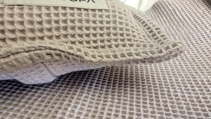 Close-up of a textured, luxurious bath product featuring a honeycomb weave, showcasing its softness and quality.