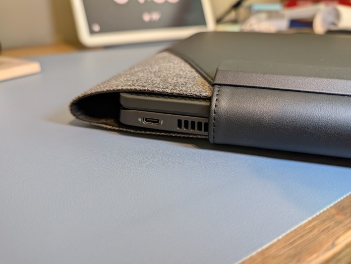 Close-up view of the LOC8 Laptop Sleeve Universal, partially open to show a laptop inside, on a blue surface.