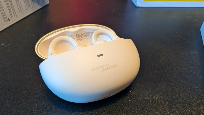 A close-up of the Baseus Inspire XP1 True Wireless Earbuds resting in their charging case, featuring a sleek white design with 'Sound by Bose' branding.