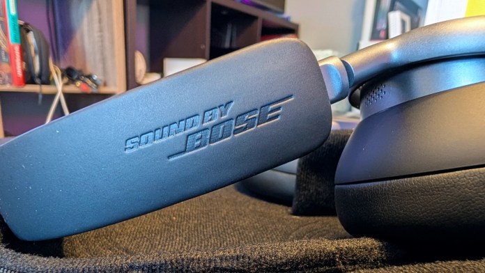 Close-up of the Baseus Inspire XH1 Noise-Cancelling Headphones showcasing the 'Sound by Bose' branding on the earcup.