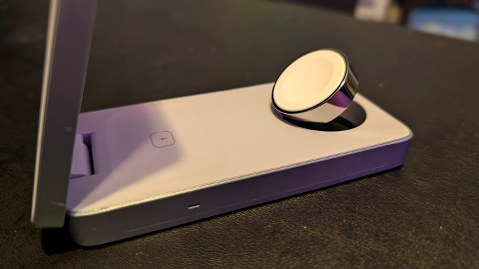 UGREEN MagFlow 3-in-1 Magnetic Wireless Charger on a black surface, showcasing a sleek design with magnetic alignment for charging Apple devices.