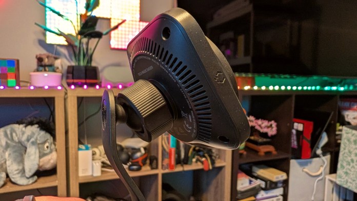 Close-up of the ESR OmniLock Magnetic Car Charger showing its side profile and adjustable mounting mechanism, set against a colorful background with various tech accessories.