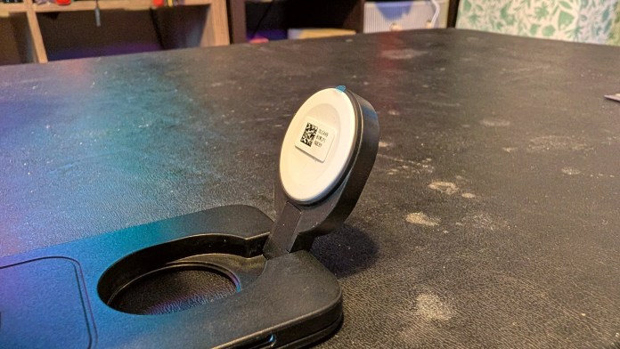 Close-up of an ESR CryoBoost Magnetic Charging Station on a textured surface, showing the charging pad and its adjustable stand.