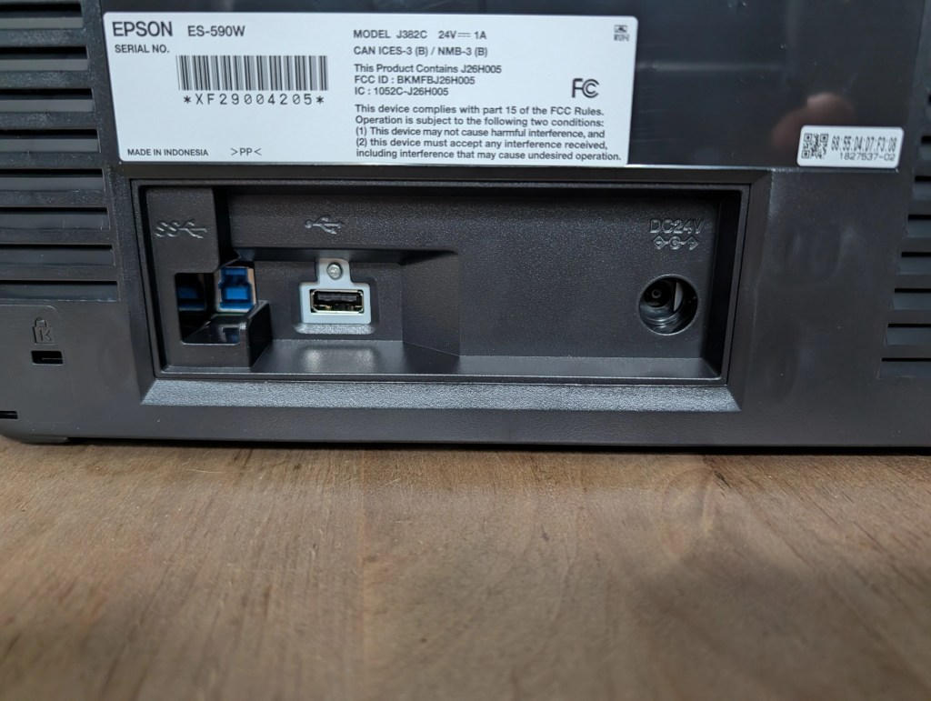 Back view of an Epson ES-590W printer showing power connection and USB ports.