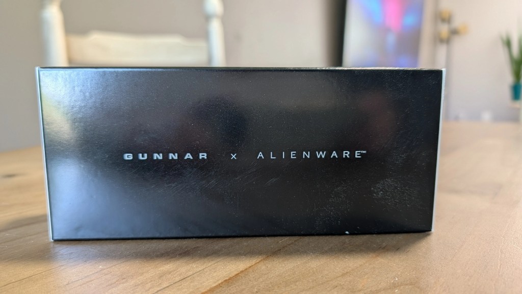Close-up of a black box featuring the logo 'GUNNAR x ALIENWARE' on the front.