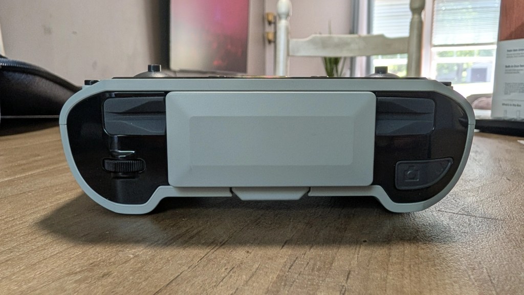 Close-up view of a gaming console or handheld device from the front, showing buttons and controls.