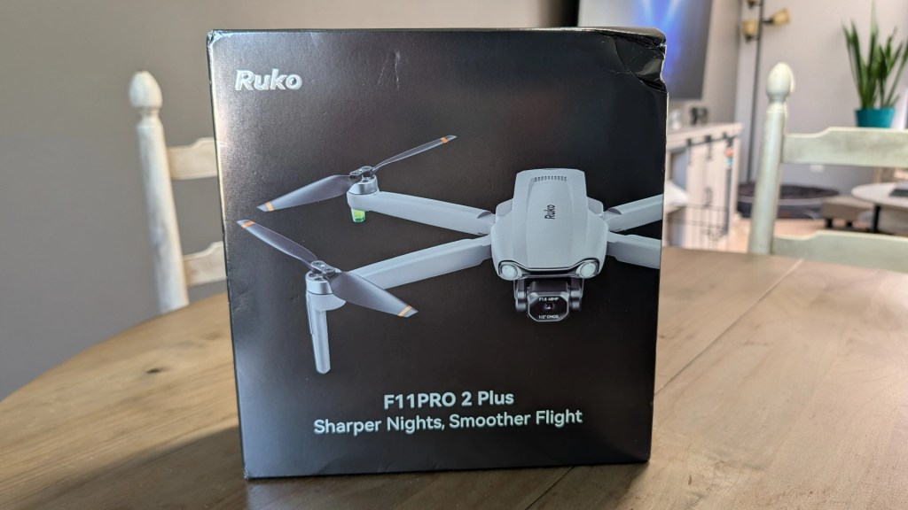 Packaging of the Ruko F11PRO 2 Plus drone, featuring a sleek design and promotional text highlighting sharper night photography and smoother flight capabilities.