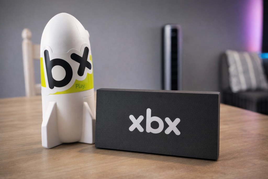 A white rocket-shaped container labeled with 'bx Play' next to a black rectangular box with the letters 'xbox' in white text.